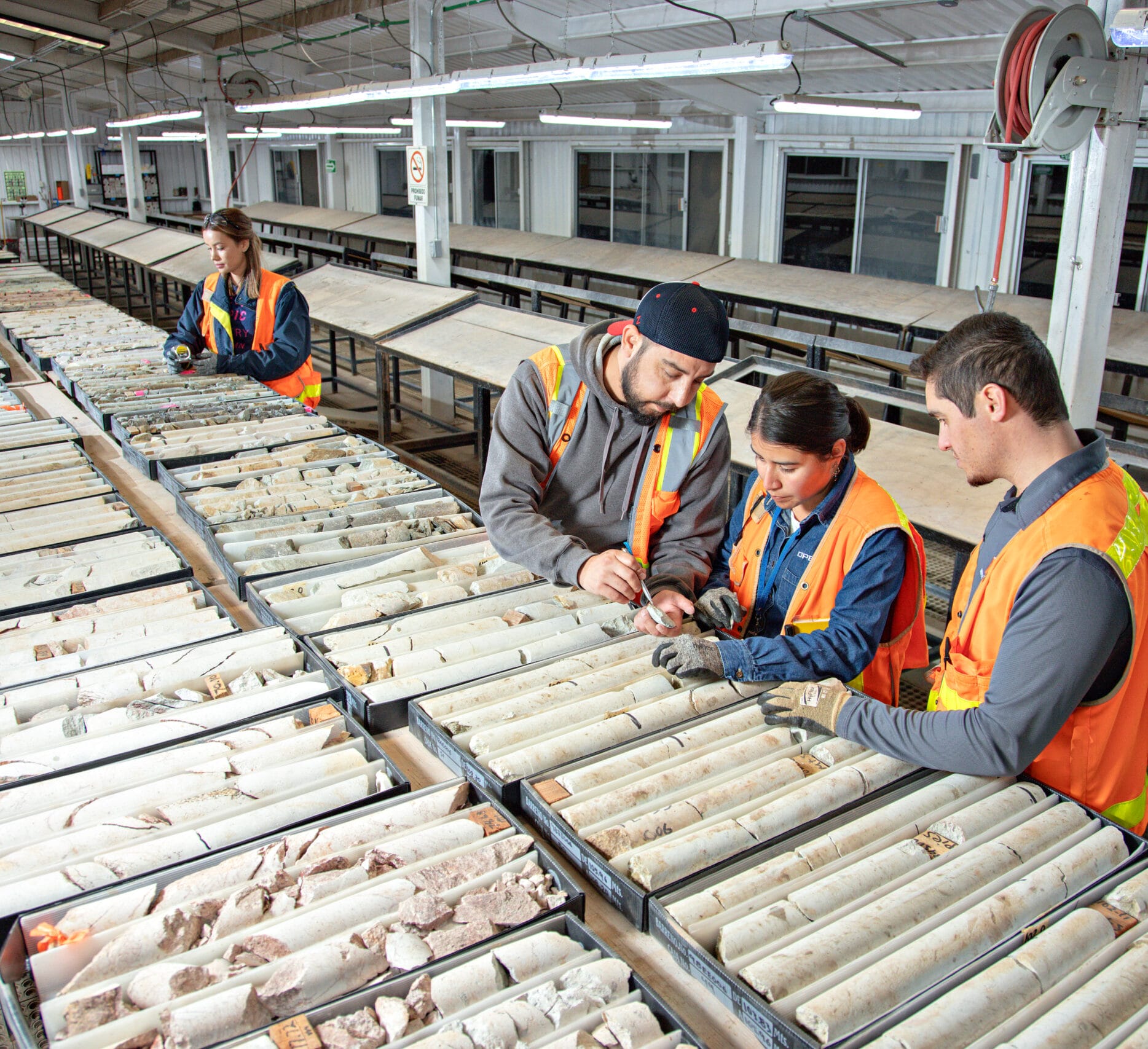 Four people working in core shack.