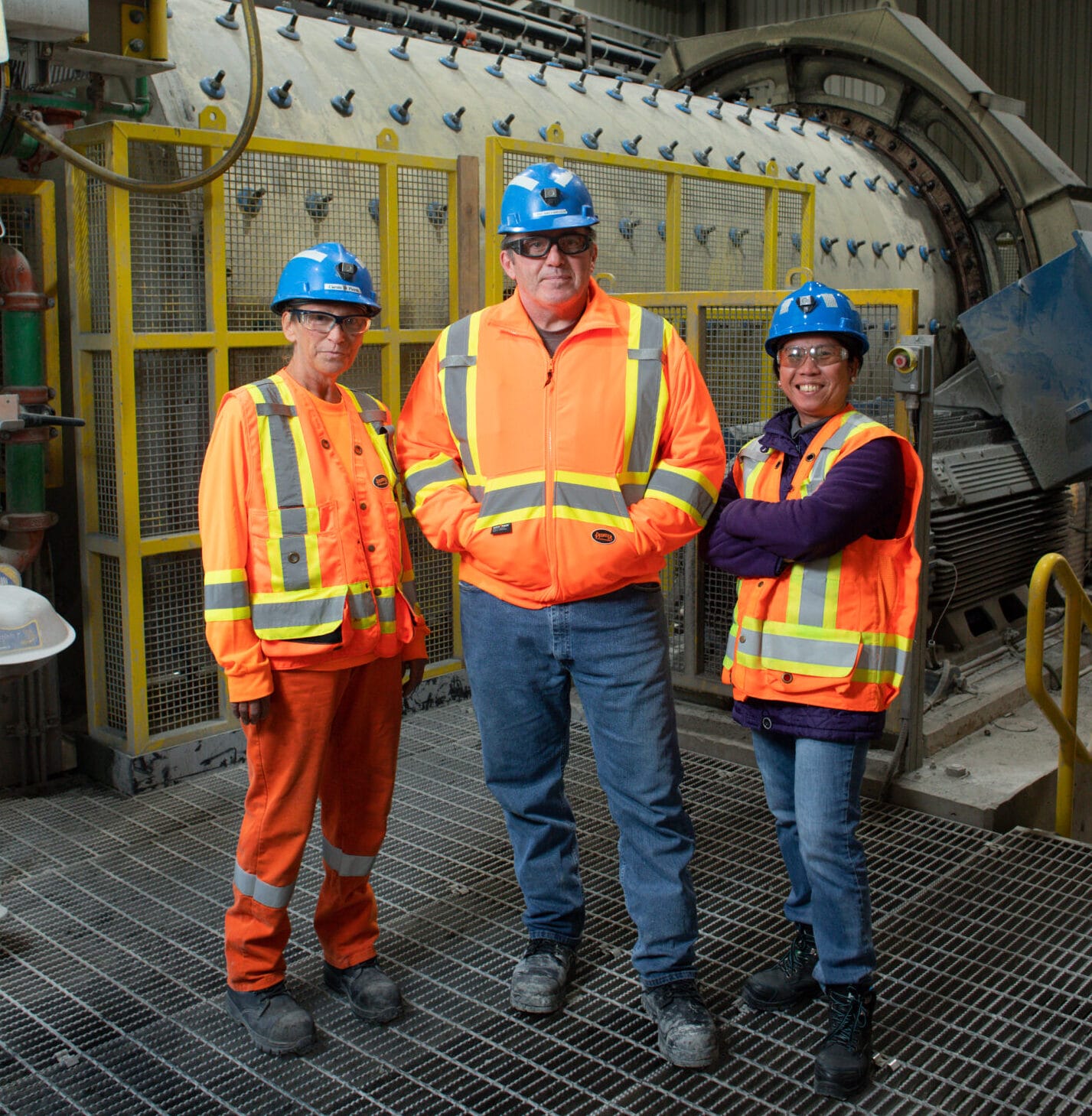Three people posing for photo in mine
